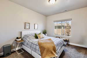 Bedroom 2 featuring large valenced window for natural light.