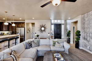 View of entry to home with tiled flooring, carpeted Great Room and lots of natural light.
