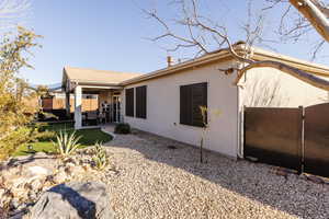 View of side of home with a covered patio and south gate.