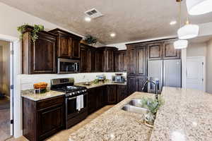 View of kitchen with granite countertops, and tiered island.