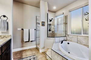 Primary bath with soaker tub, walk-in shower, and double vanity.