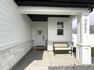 Property entrance with covered porch and a mountain view