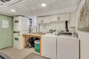 Shared laundry room with stacked dryers and two washers. Coin or credit card operated