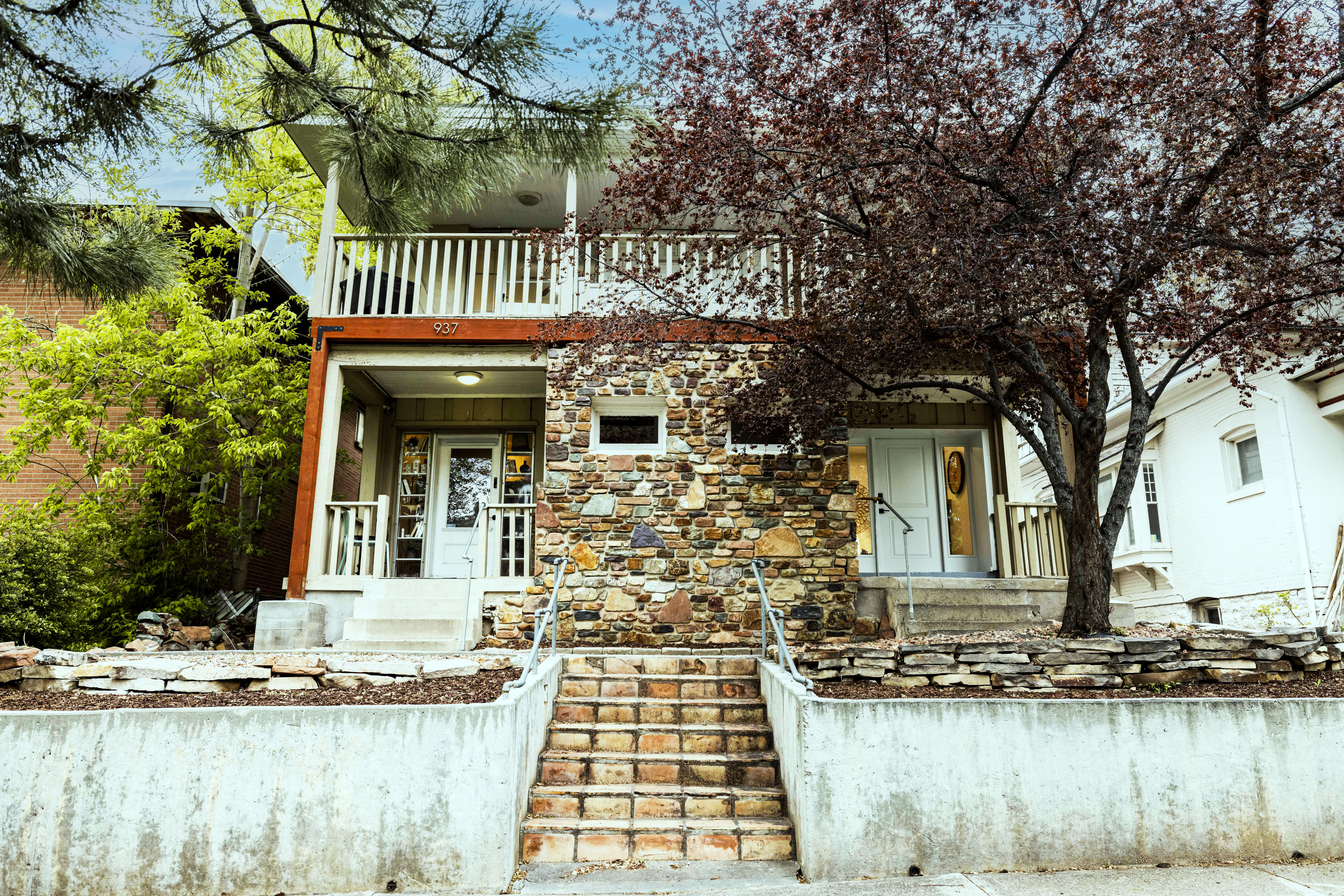 View of front of property featuring private balconies and porch's