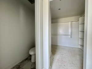Bathroom featuring toilet and baseboards