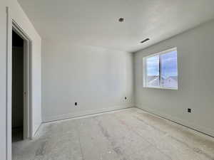 Empty room featuring a textured ceiling and baseboards