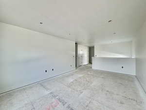 Spare room featuring baseboards and a textured ceiling