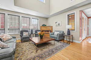 Great room featuring a gas fireplace, and  high ceiling