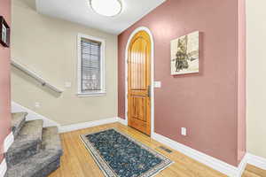 Entryway featuring arched door