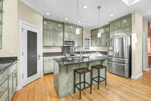 Kitchen with stainless steel appliances, granite countertops and kitchen island.