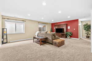 Living area featuring light colored carpet and recessed lighting
