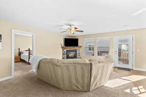 Living room featuring a fireplace and ceiling fan