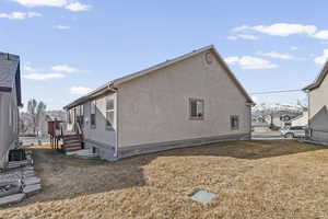 View of home's exterior with a lawn and stucco siding