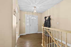 Foyer featuring wood finished floors and baseboards