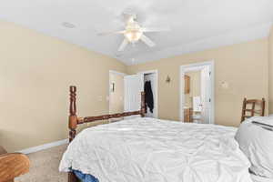 Bedroom featuring light colored carpet, a closet, and ceiling fan
