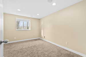 Unfurnished room featuring carpet floors and recessed lighting