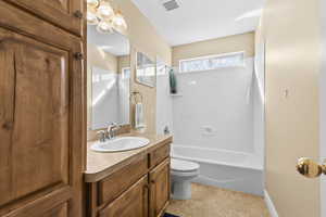 Full bath with vanity, shower / bathtub combination, and light tile patterned floors
