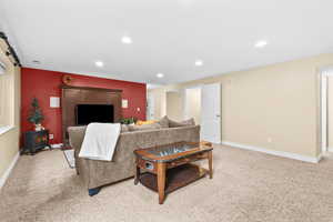 Living room with light carpet and recessed lighting