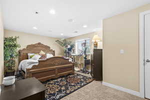 Bedroom with light carpet and recessed lighting
