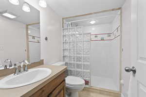 Bathroom featuring a shower stall, vanity, and light tile patterned floors