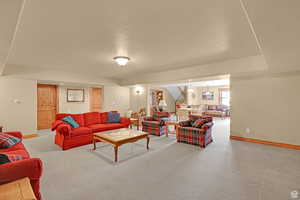 Living area featuring light colored carpet and baseboards