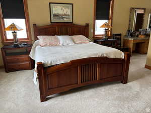 Bedroom featuring light carpet