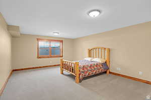 Carpeted bedroom featuring baseboards