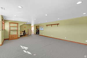 Basement featuring a desk, recessed lighting, and carpet floors