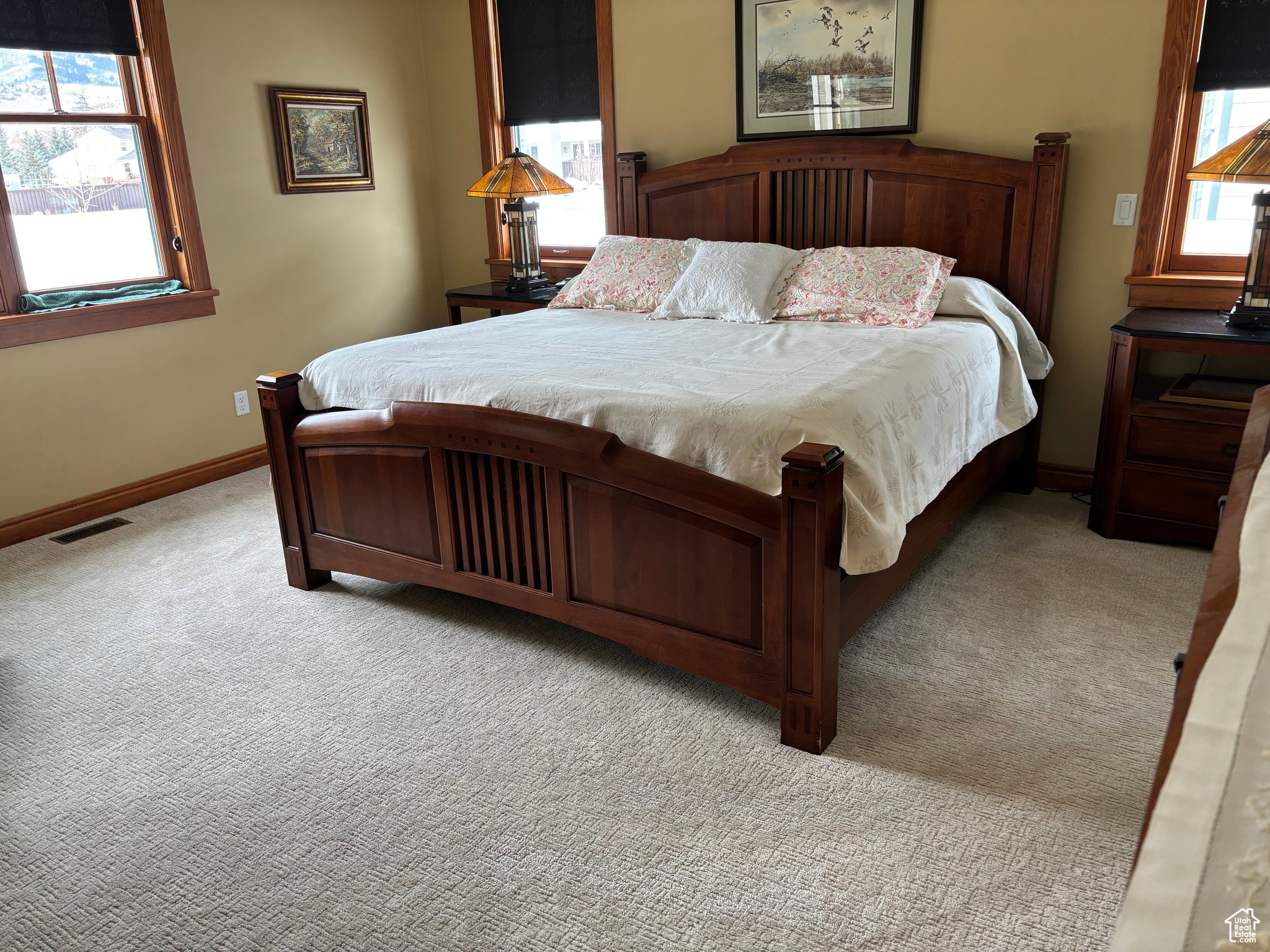 Bedroom with multiple windows and carpet