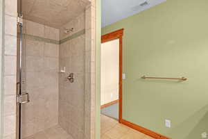 Full bathroom with a shower stall and tile patterned floors