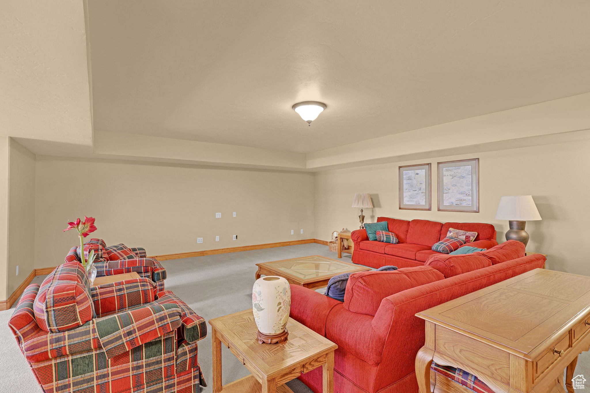 Living area featuring baseboards and carpet floors