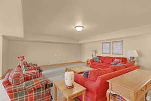 Living area featuring baseboards and carpet floors