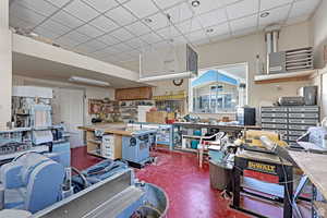 Interior space featuring a heating unit, a workshop area, and a paneled ceiling