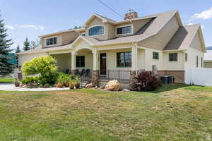 Craftsman inspired home featuring covered porch, roof with shingles, board and batten siding, and a chimney