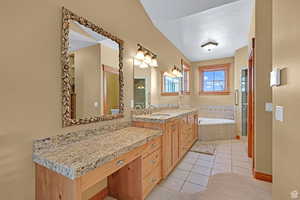 Full bathroom with vanity, a garden tub, light tile patterned floors, and a shower stall