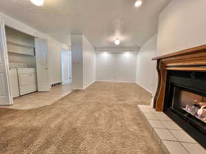 could be used as a 3rd bedroom, includes a large window, laundry, bathroom, exits out the garage as well.
