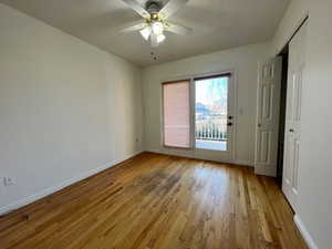 Main floor bedroom with hardwood flooring and door to big patio overlooking stream