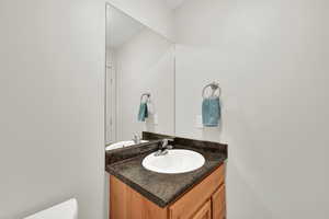 Half bath with vanity and toilet