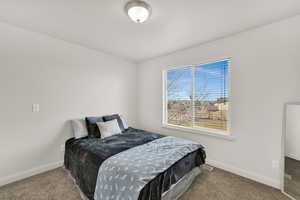 Carpeted bedroom featuring baseboards