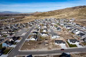 Aerial overview of property's location featuring nearby suburban area and a mountainous background