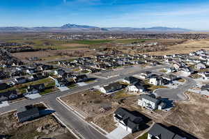 Aerial overview of property's location featuring a mountainous background and nearby suburban area