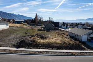 Aerial perspective of suburban area featuring a mountainous background
