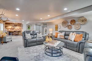 Carpeted living room featuring recessed lighting