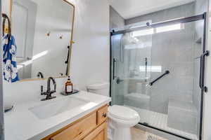 Full bathroom featuring vanity and a shower stall