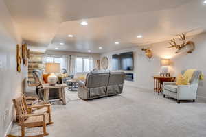 Living room with light colored carpet and recessed lighting