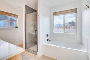 Bathroom with vanity, a shower stall, light tile patterned flooring, and a bath