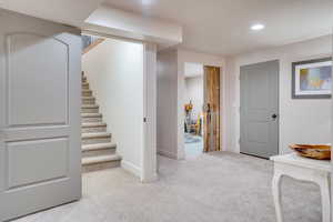Basement featuring light colored carpet and recessed lighting