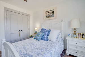 Bedroom with a closet and dark wood finished floors