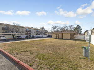View of grassy yard with an outdoor structure