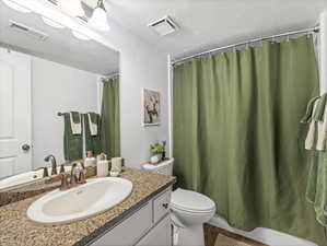 Full bath with vanity and shower / bath combo with shower curtain